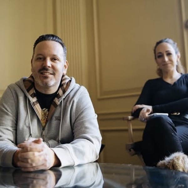 Doron Fetman and Toby Hassan-Fishman seated together at a table in their office